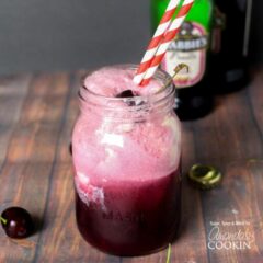 A glass of beer on a table, with Cherry