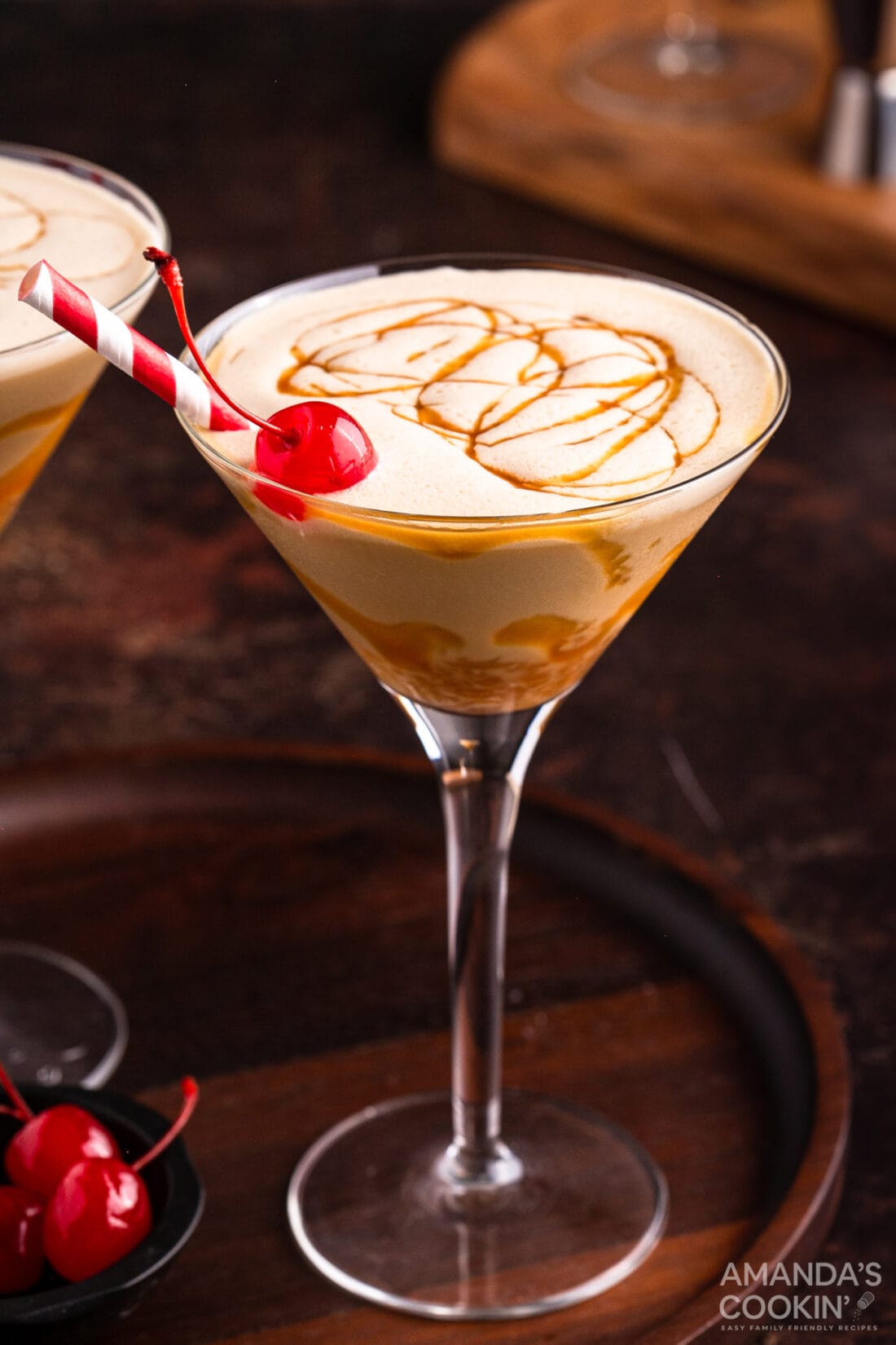 butterscotch milkshake cocktail in a martini glass with a cherry garnish