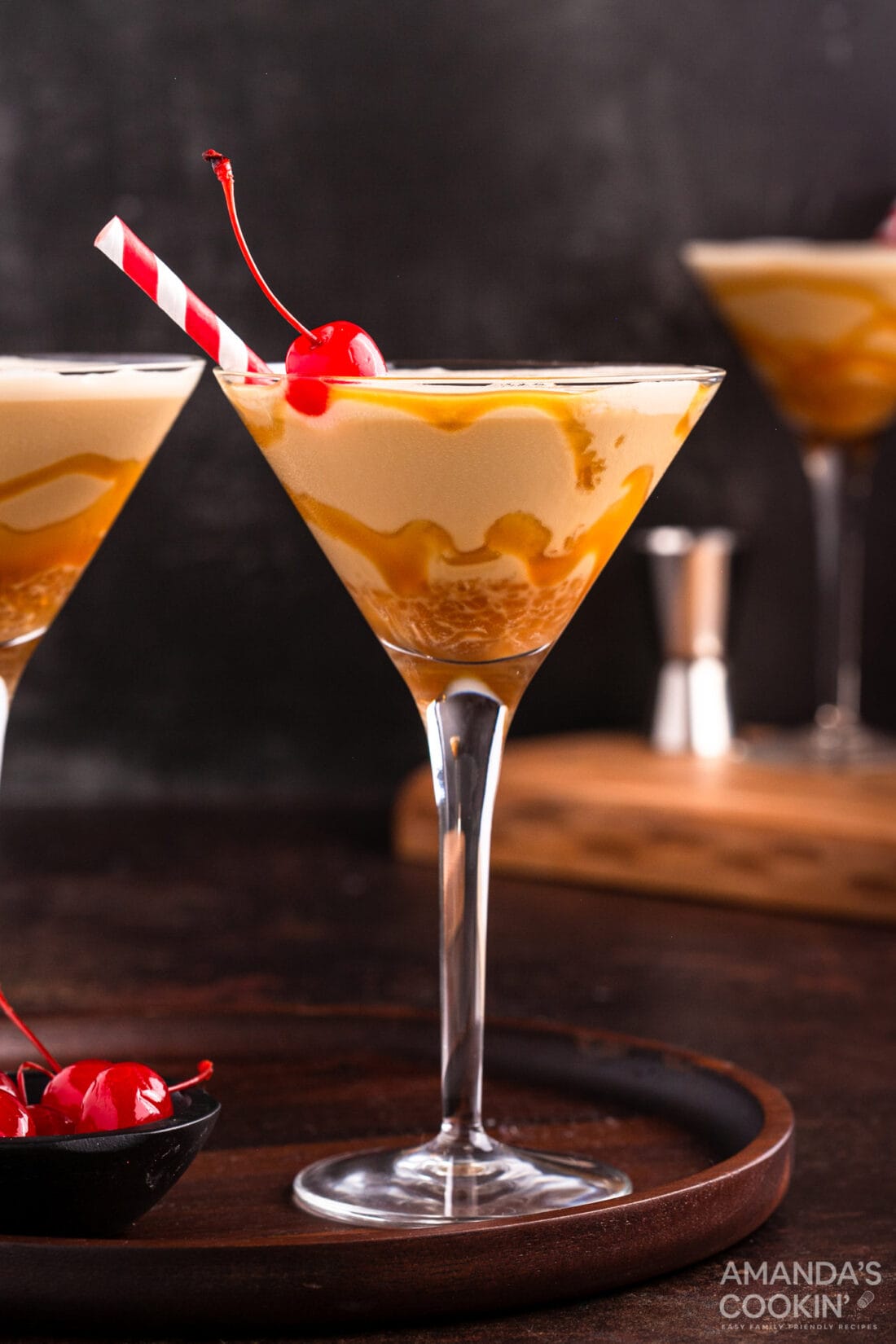 butterscotch milkshake cocktail in a martini glass with a cherry garnish
