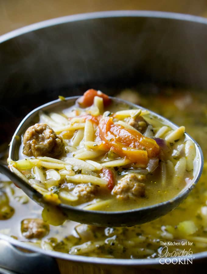 italian sausage orzo soup in a ladel