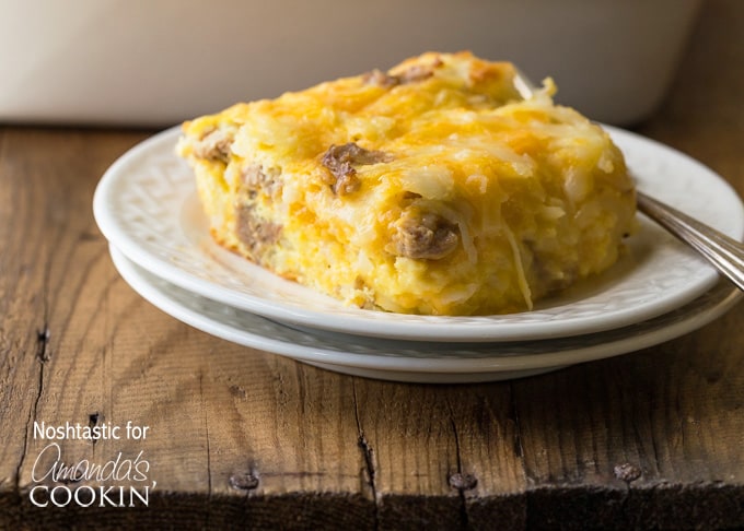 A square serving of turkey hash brown breakfast casserole on a white plate.