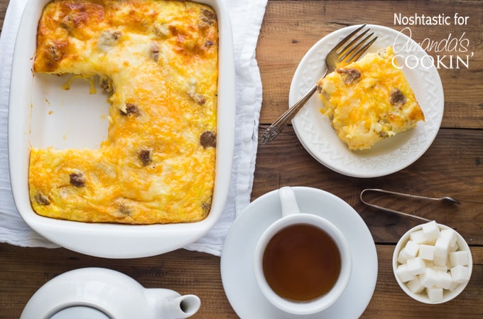 An overhead photo of a pan of turkey hash brown breakfast casserole with a serving resting on a plate to the side.