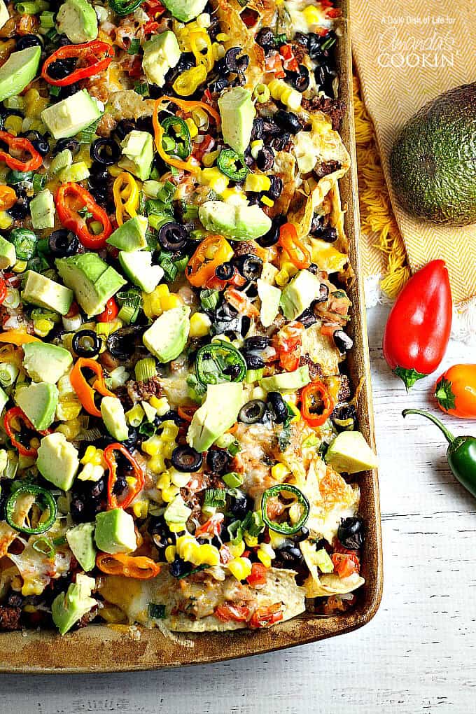 An overhead of loaded nachos on a sheet pan.