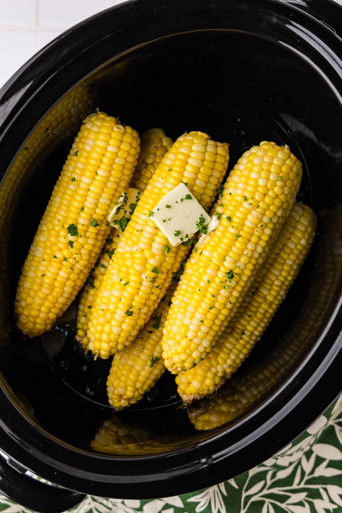 overhead photo of corn on the cob in a crockpot