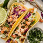 overhead of Salmon Tacos with toppings