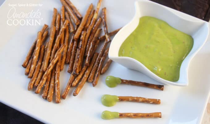 A plate with pretzel sticks, a bowl of boogers (cheese wiz), and boogers on a stick.