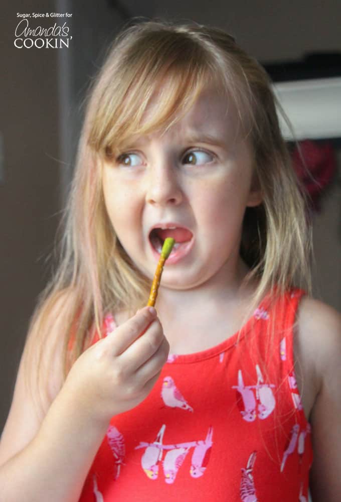 A little girl eating a pretzel