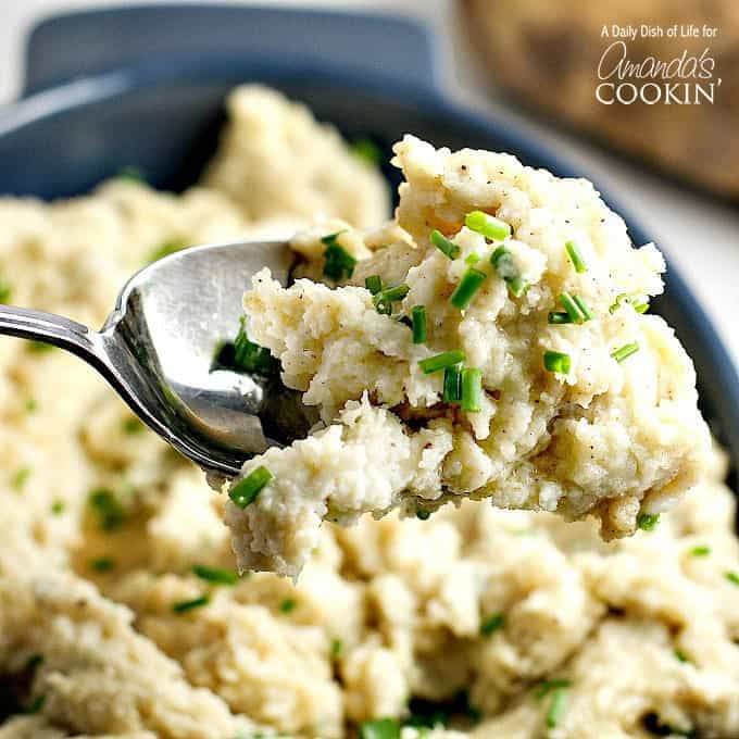 A close up picture of a spoonful of mashed potatoes.