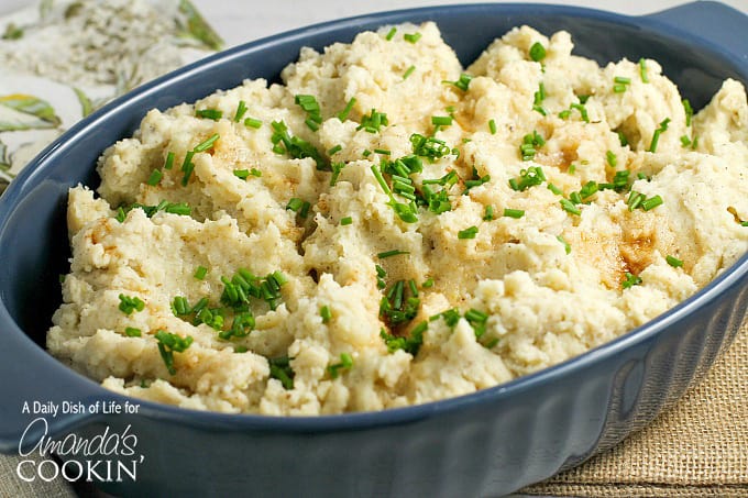 A bowl of brown butter mashed potatoes with chives on top.