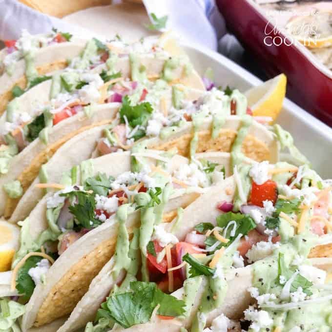 A close up photo of salmon tacos resting in a casserole dish.