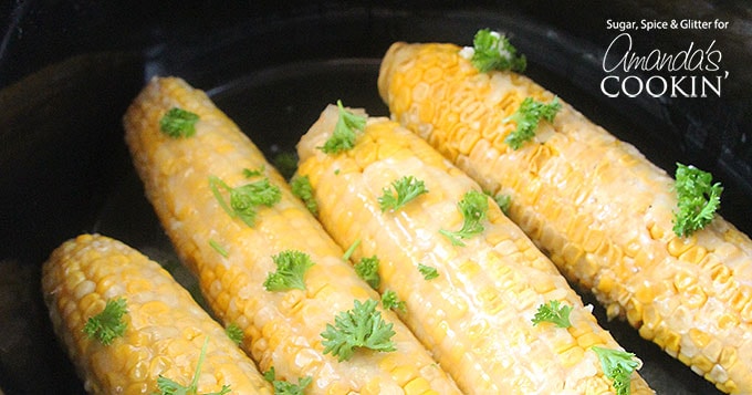 A close up of corn on the cob in a crockpot.