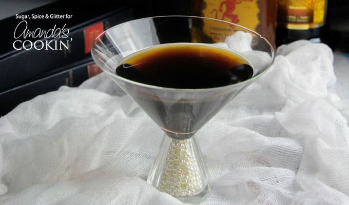 A clear martini glass filled with a raven coffee cocktail.