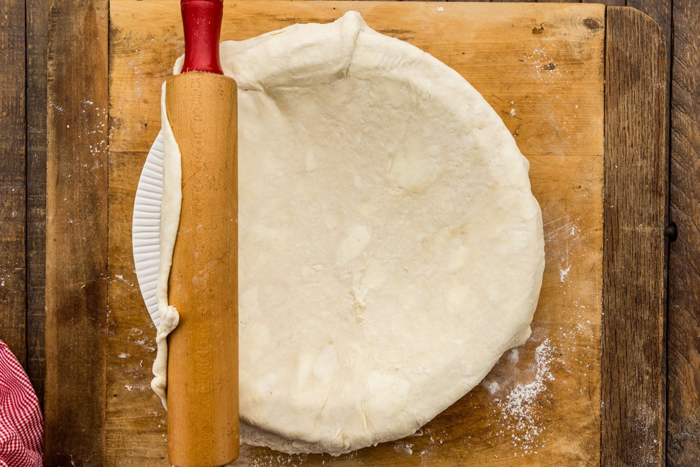 adding pie crust to pan
