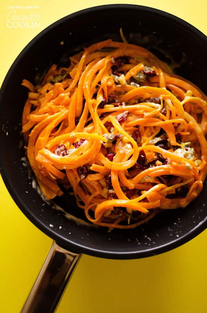 A large saute pan filled with butternut squash pasta.