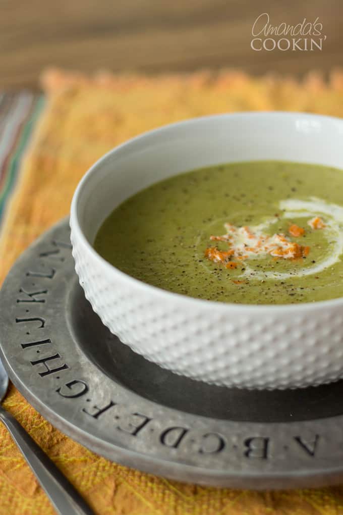 A white bowl filled with cream of asparagus soup.