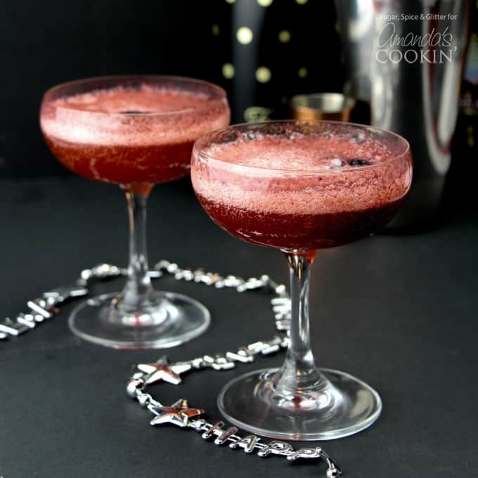 Champagne cocktails in glasses with blackberries