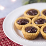 plate of cookie cups filled with chocolate