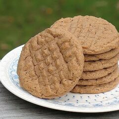 A close up photo of a stack of Nutella peanut butter cookies resting on a plate.