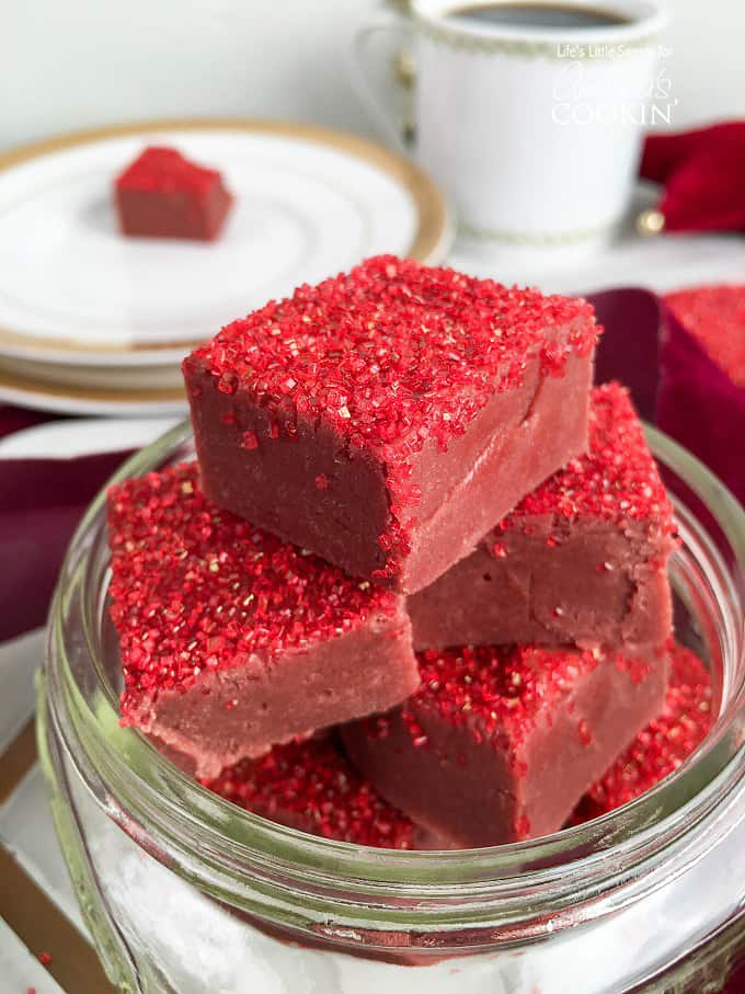 Squares of red velvet fudge with red sprinkles on top.