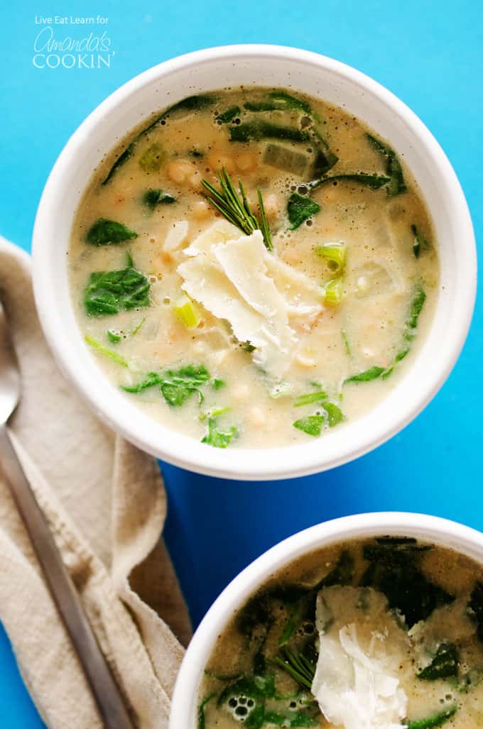 A close up of white bean soup in a white bowl.