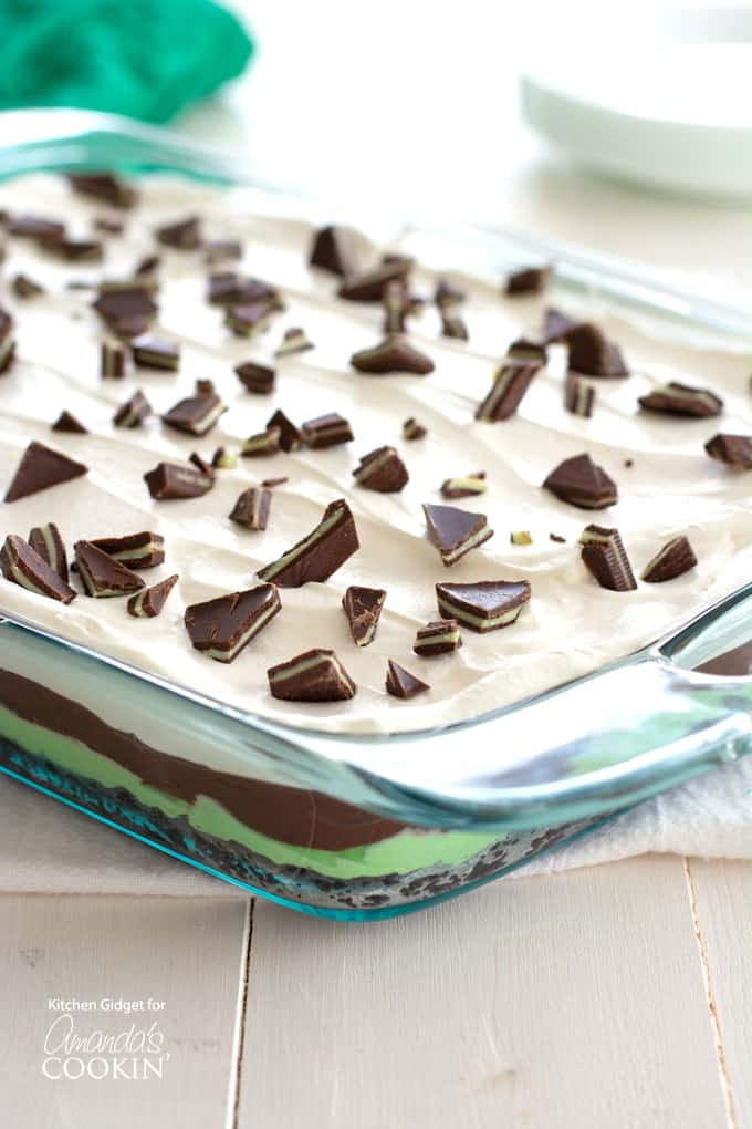 Mint chocolate lasagna in baking pan topped with chopped Andes mints