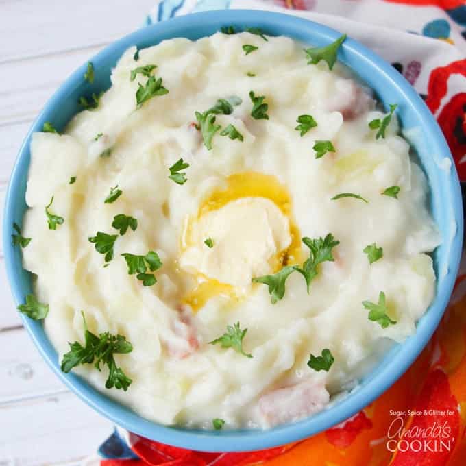 A bowl of Colcannon mashed potatoes with chopped parsley and melted butter.