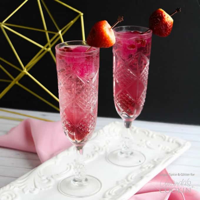 2 pink cocktails in champagne glasses