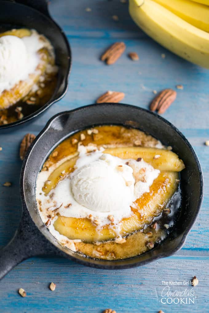 Single serve banana foster topped with vanilla ice cream in a 5\" skillet.