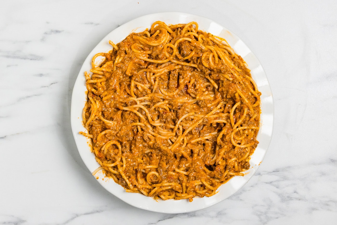 Spaghetti mixture spread into a deep dish nine inch pie plate