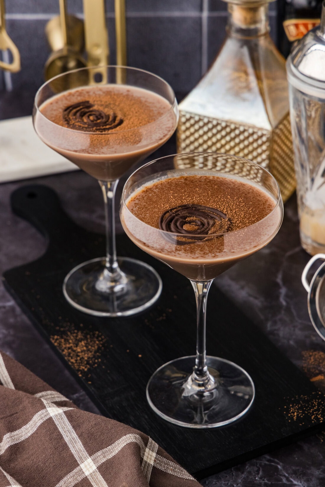 Two Baileys Chocolate Martinis on a black wooden platter