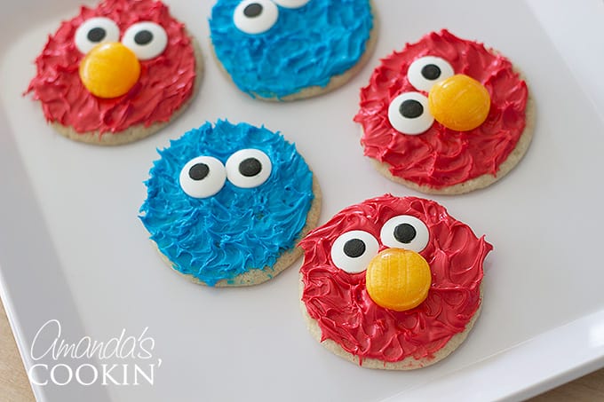 elmo and cookie monster cookies on a white table