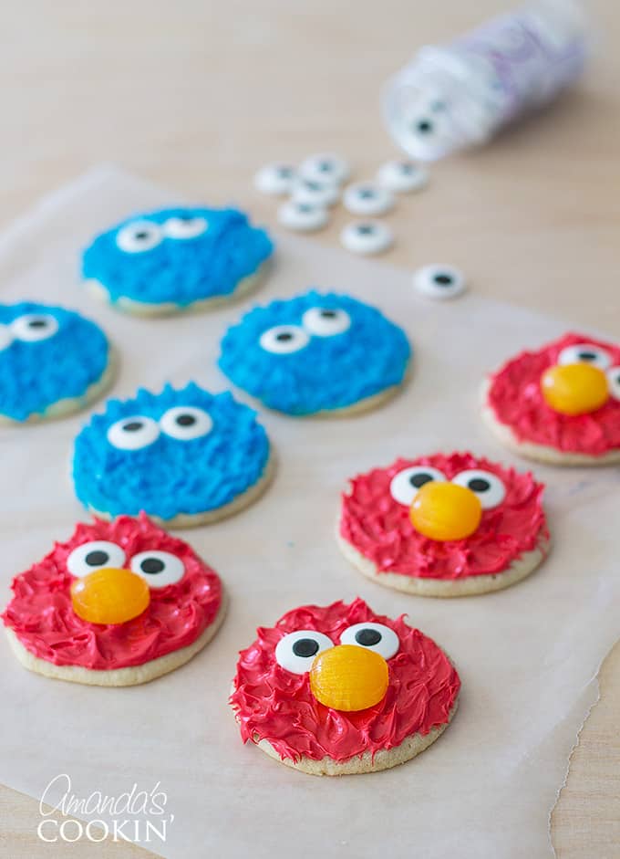 elmo and cookie monster decorated cookies on parchment