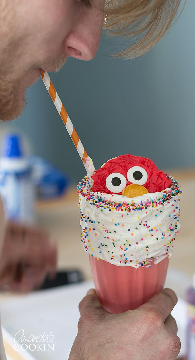 Boy drinking elmo freakshake out of straw