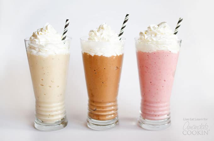 three shakes with whipped cream and straws