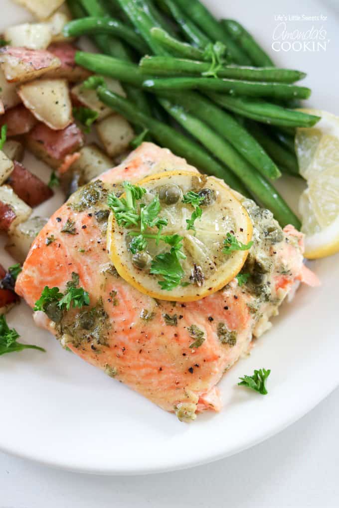 Red potatoes, green beans and dijon caper salmon served on a plate