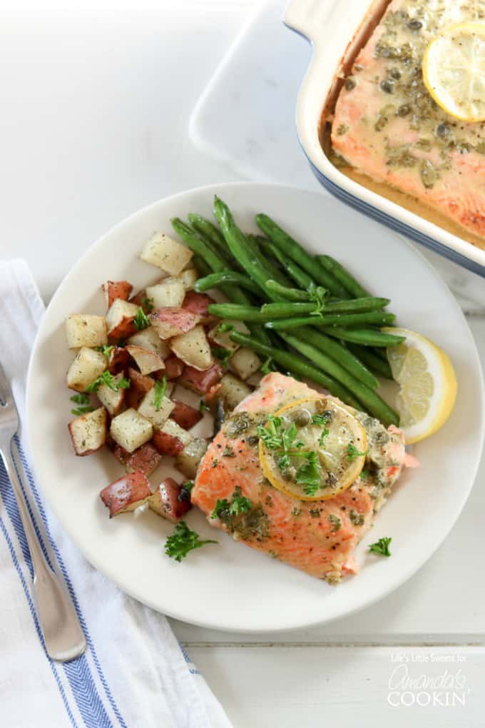 A plate of salmon with potatoes and green beans