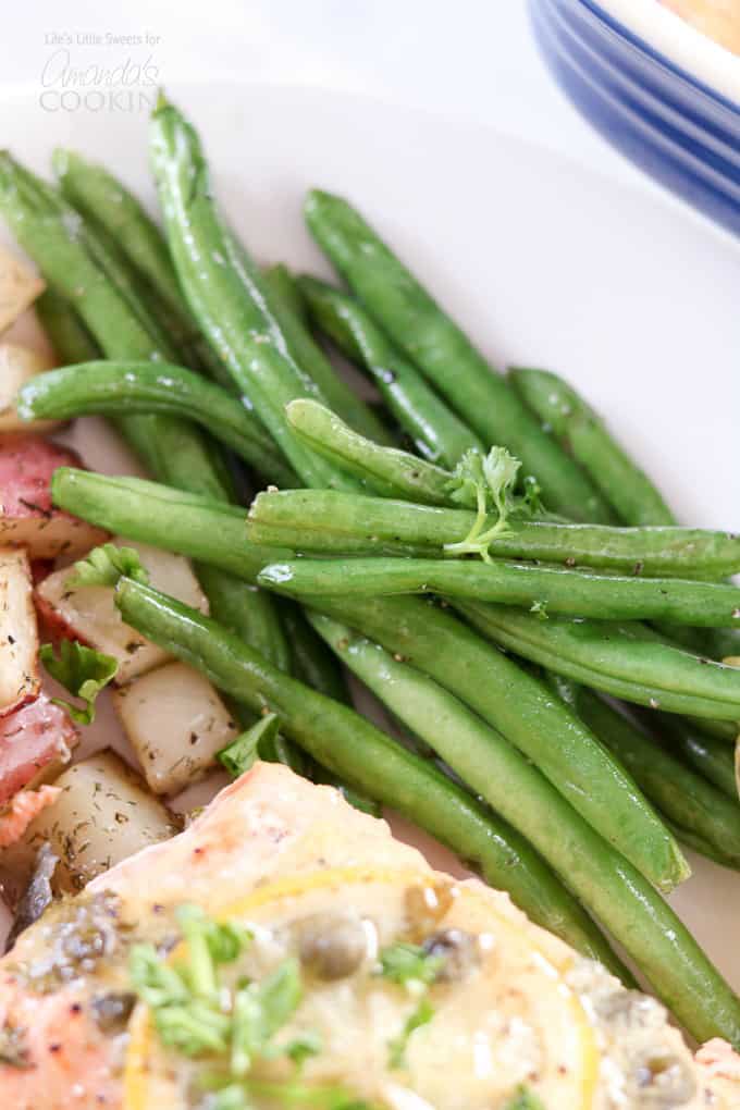 A plate of salmon with potatoes and green beans