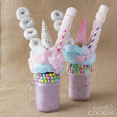 two purple milkshakes with donuts and marshmallows
