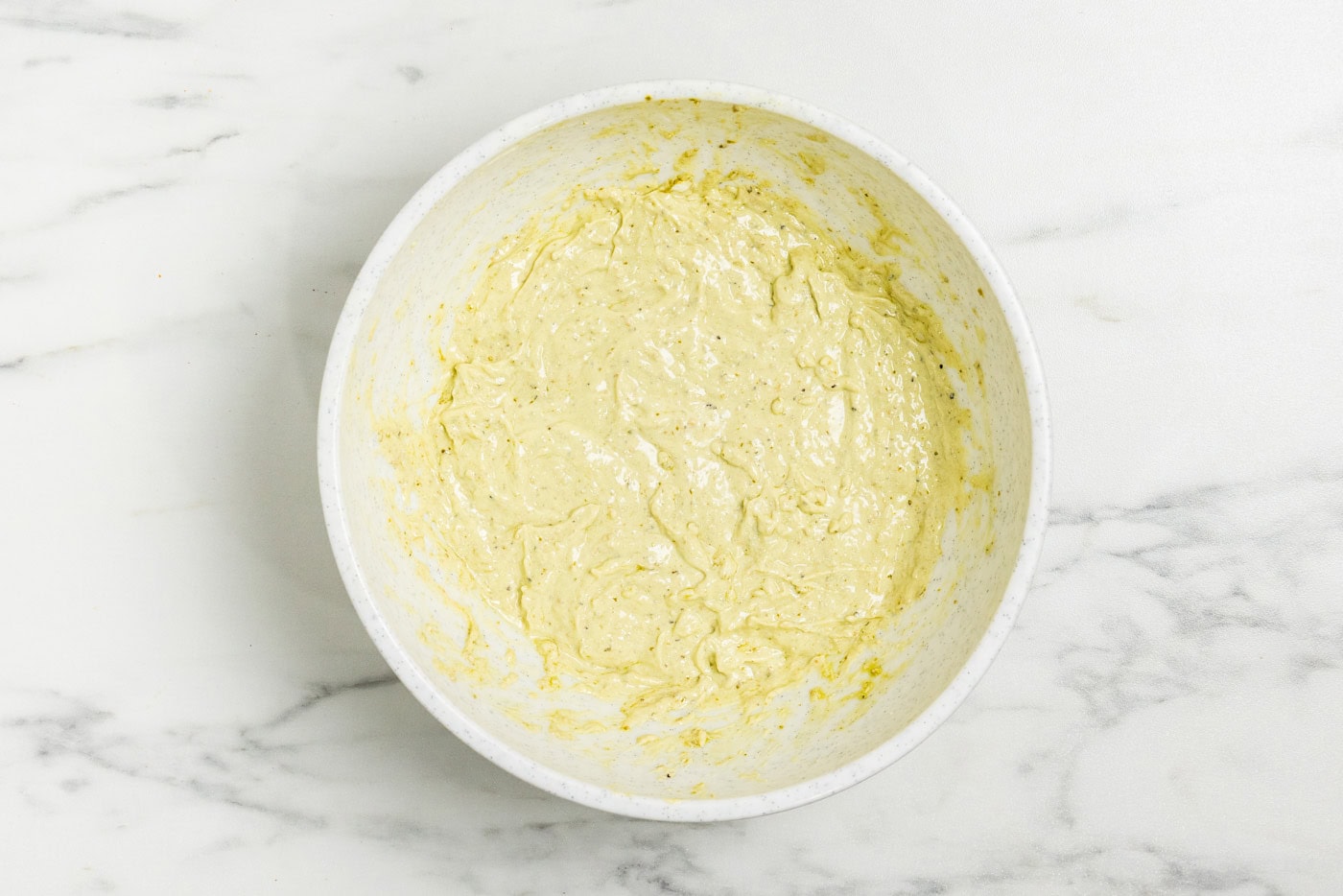 Tortellini Pesto Pasta Salad dressing in bowl