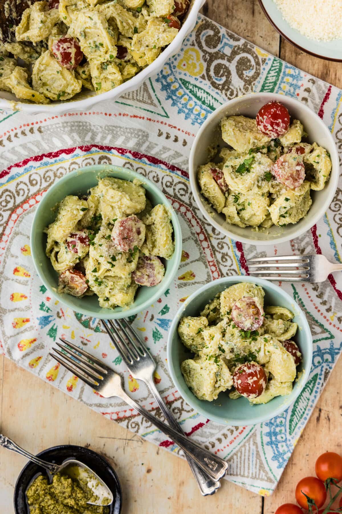 overhead photo of Tortellini Pesto Pasta Salad in 3 little bowls