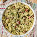 overhead of serving bowl full of Tortellini Pesto Pasta Salad