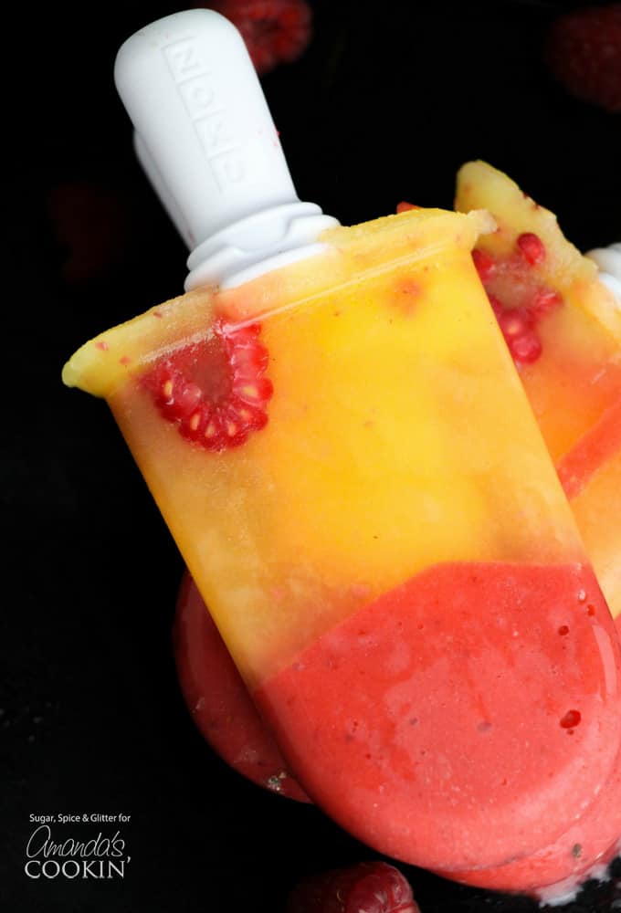 Delicious boozy frozen mango raspberry popsicles!
