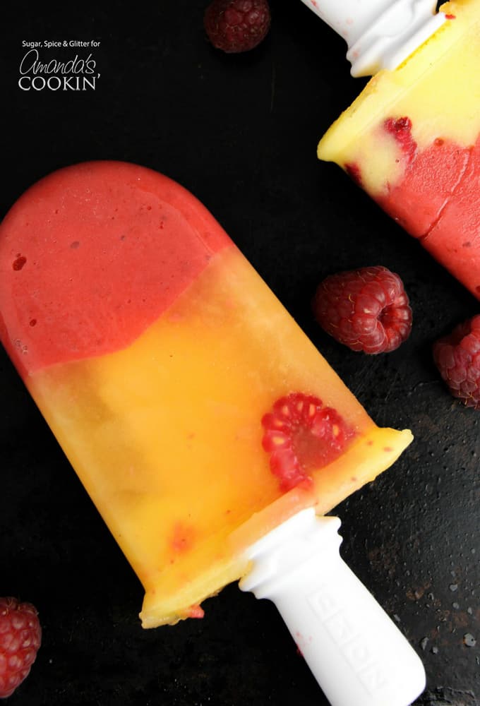 Adult friendly vodka and limoncello infused mango raspberry popsicles