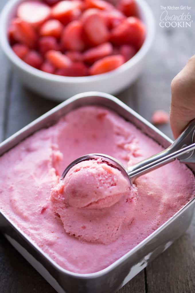 Scooping strawberry frozen yogurt