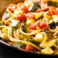 close up of zucchini tomato pasta in a bowl