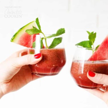 women clinking glasses of watermelon smoothies