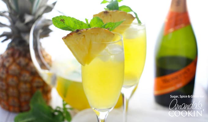 Pineapple prosecco punch in flute with pineapple wedge garnish