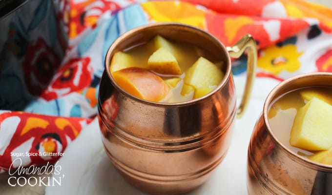 Crockpot Caramel Apple Cider in cup with apples