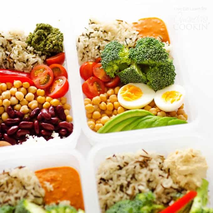 A plastic container filled with rice, eggs, broccoli