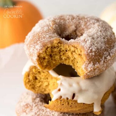 stack of pumpkin donuts with bite out of it